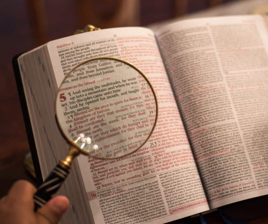 magnifying glass over Bible