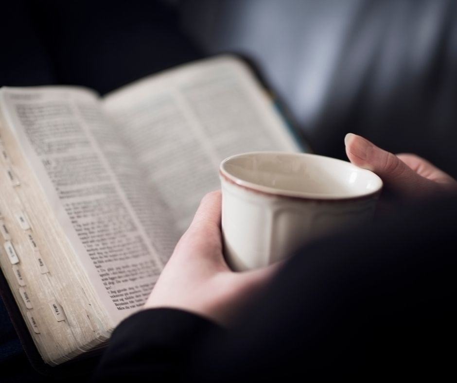 woman studying the Bible with a cup of coffee