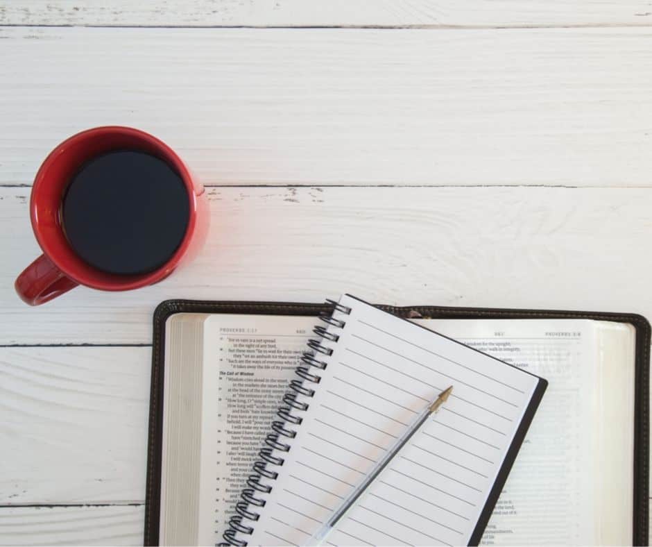 coffee cup, notebook, pen, and Bible laid out for the SOAP Bible study method