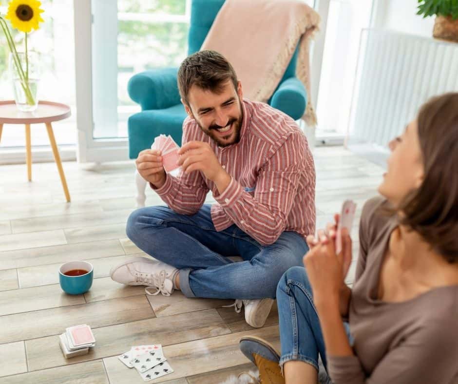 couple playing cards at home
