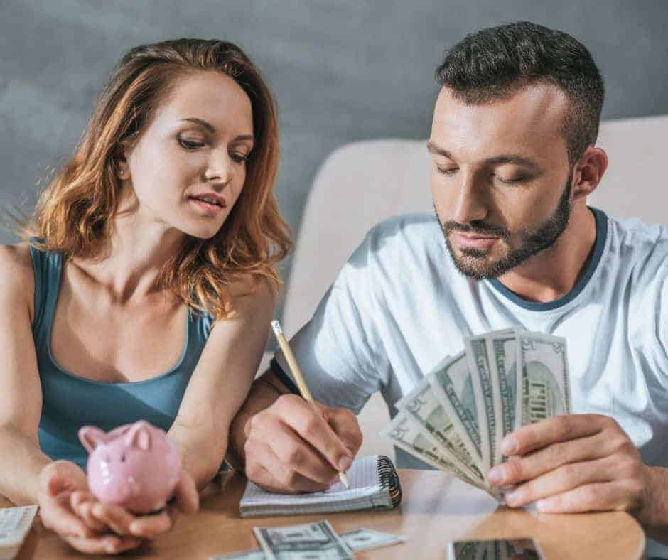 christian married couple counting money and managing finances together