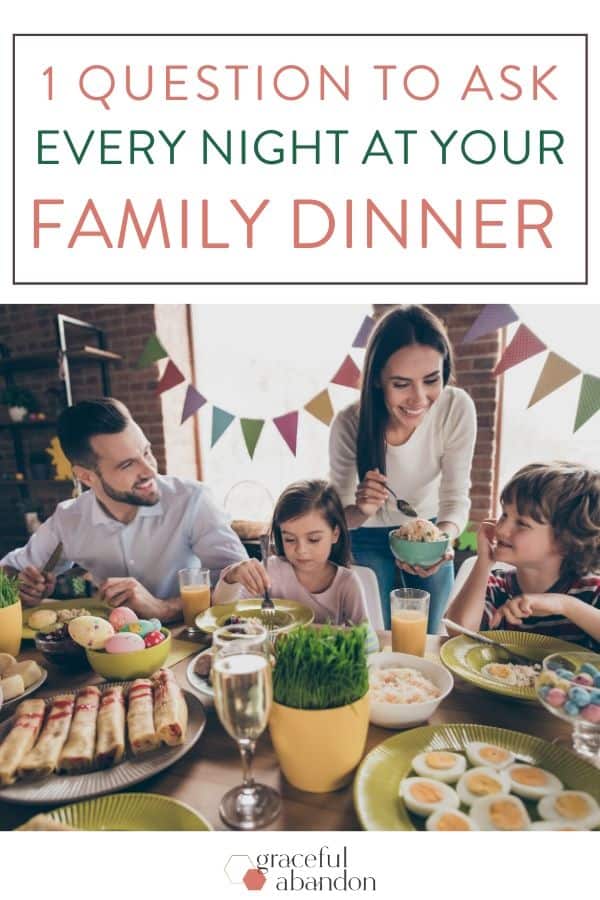 family around dinner table talking with happy family culture